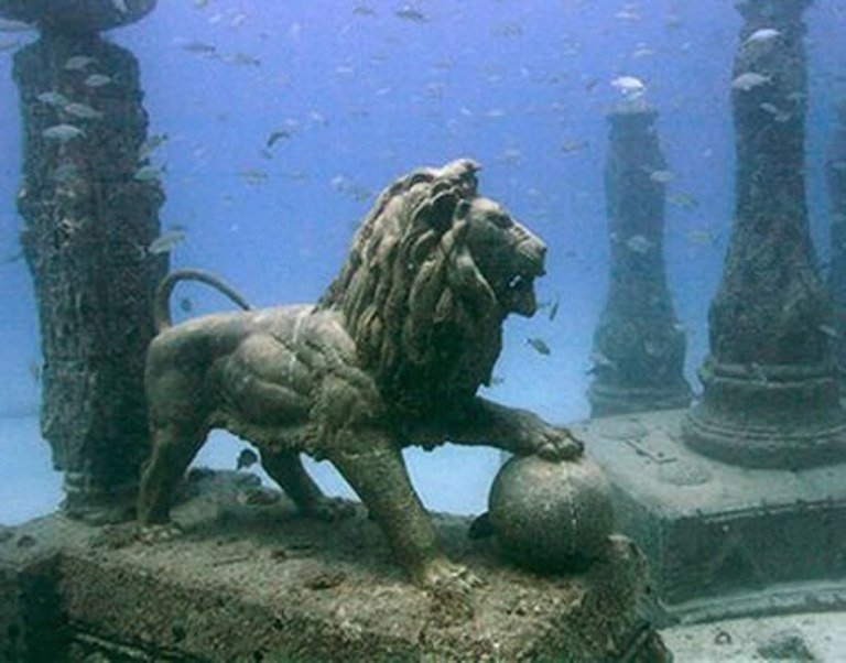 A lion statue standing underwater.