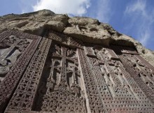 a row of khachkars at Geghard Monastery