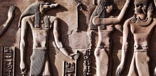 This relief from the Temple of Kom Ombo shows Sobek with typical attributes of kingship, including a was-sceptre and royal kilt. The ankh in his hand represents his role as an Osirian healer and his crown is a solar crown associated with one of the many forms of Ra.