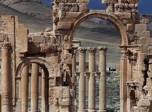 A file picture taken on March 14, 2014 shows visitors walking near the famous Arch of Triumph of the ancient oasis city of Palmyra, 215 kilometres northeast of the Syrian capital Damascus. AFP Photo