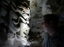 Garrison comes face to face with a mask inside one of the site’s pyramids. (USC Photo/Robert Perkins)