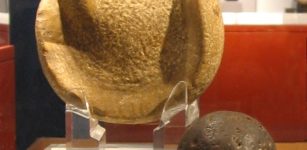 A solid rubber ball used (or similar to those used) in the Mesoamerican ballgame, 300 BCE to 250 CE, Kaminaljuyu. The ball is 3 inches (almost 8 cm) in diameter, a size that suggests it was used to play a handball game. Behind the ball is a manopla, or handstone, which was used to strike the ball, 900 BCE to 250 CE, also from Kaminaljuyu. Image credit: Wikipedia