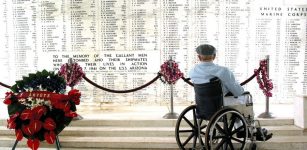 Pearl Harbor survivor Bill Johnson reads the list of names inscribed in the USS Arizona Memorial.