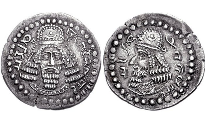 Initial coinage of founder Ardashir I, as King of Persis Artaxerxes (Ardaxsir) V. Circa CE 205/6-223/4. Obv: Bearded facing head, wearing diadem and Parthian-style tiara, legend "The divine Ardaxir, king" in Pahlavi. Rev: Bearded head of Papak, wearing diadem and Parthian-style tiara, legend "son of the divinity Papak, king" in Pahlavi