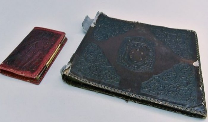 The photo album is pictured with a notebook. (Courtesy of Auschwitz Memorial Museum)