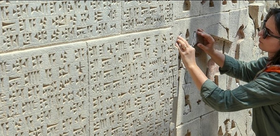 An archeologist studies stone carvings at the site of Ayanis Castle in Van, eastern Turkey, July 27, 2020. (AA Photo)