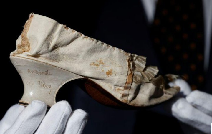 A white shoe that once belonged to Queen Marie-Antoinette, made of silk and goatskin, that was auctioned on Nov. 15, 2020, in Versailles, France