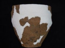 A Bronze Age food vessel unearthed during a high street demolition 42 years ago has gone on display at a nearby museum