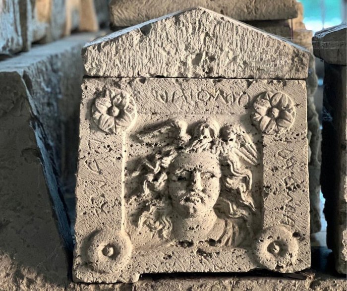 Etruscan Urn With Skillfully Adorned Medusa Relief Discovered In The Palazzone Necropolis, Perugia, Italy Etruscan Urn With Skillfully Adorned Medusa Relief Discovered In The Palazzone Necropolis